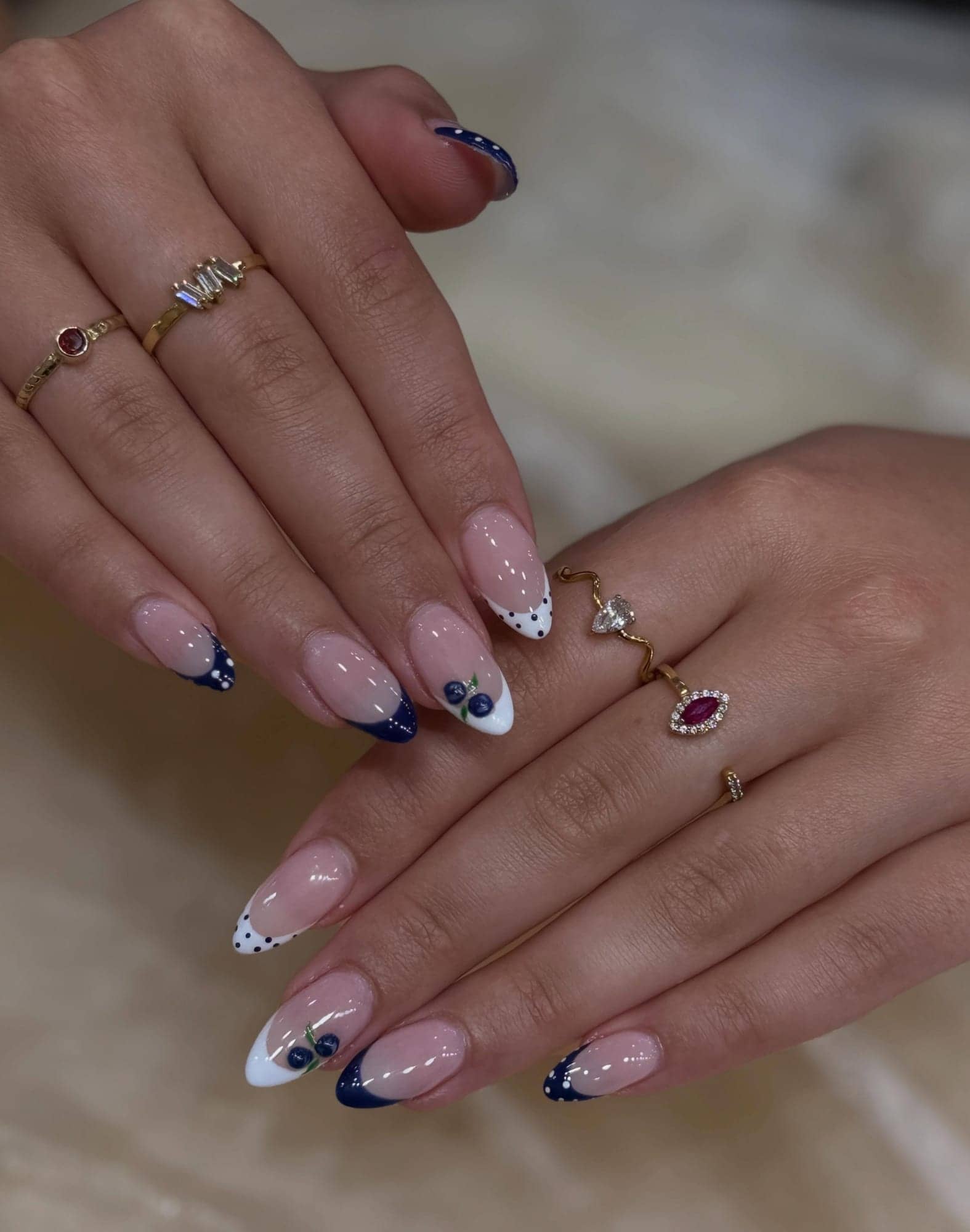 Navy and white nail art with gold detailing