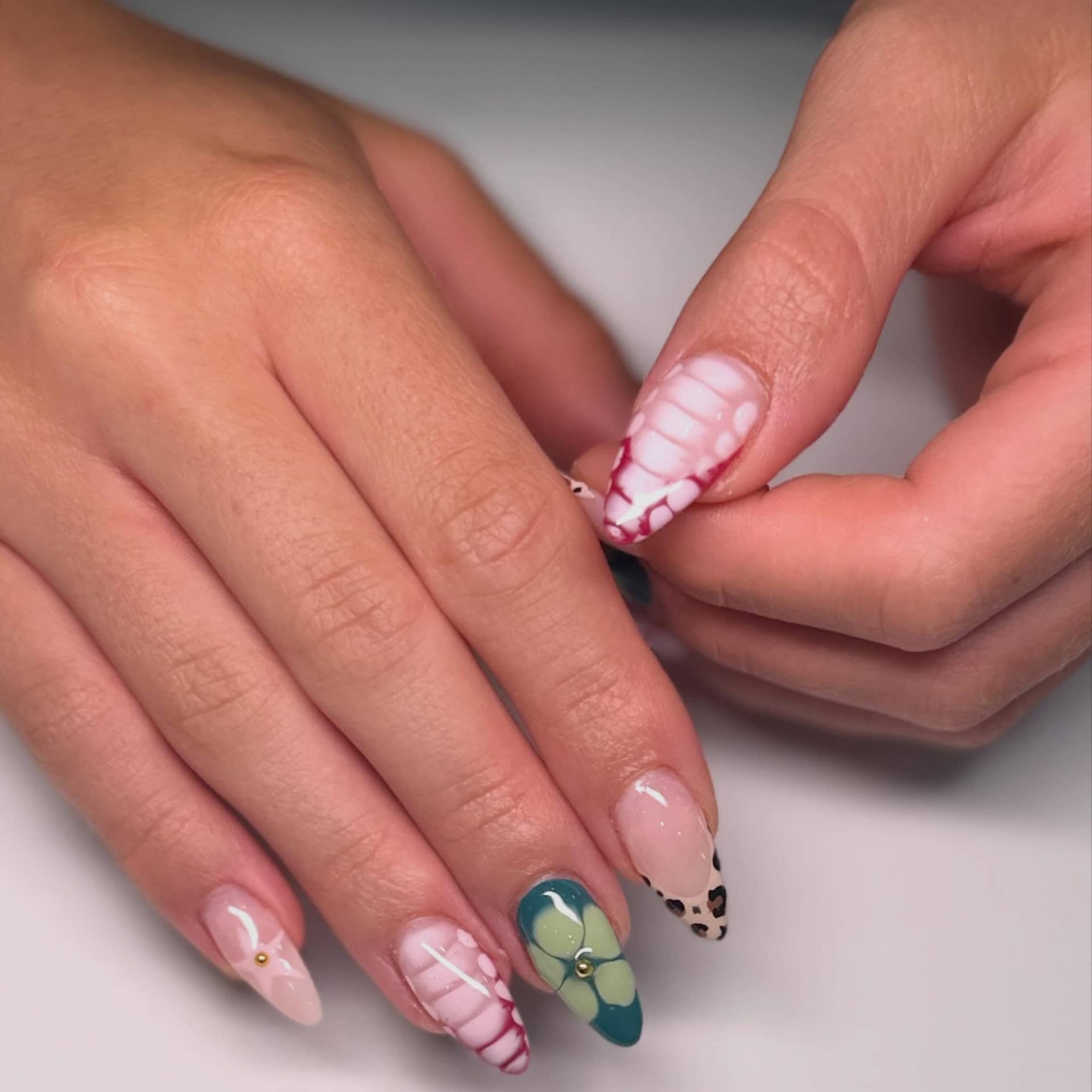 Green tortoiseshell accent nails with a nude base