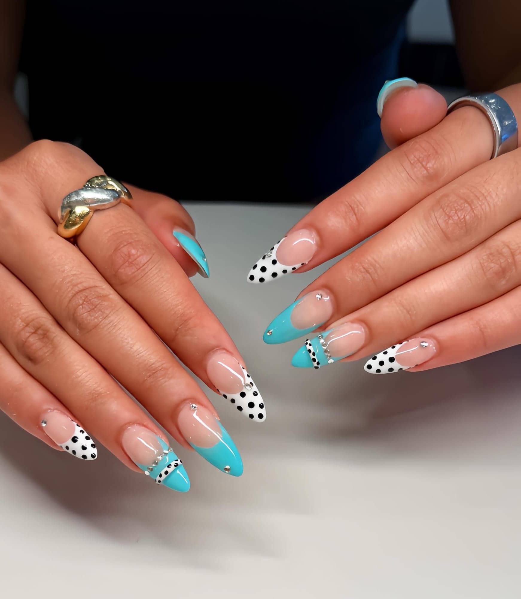 Turquoise and polka-dot French tips on long almond nails